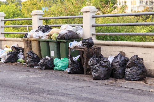 Workers inspecting a skip for safety before collection